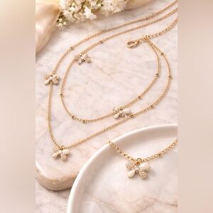 Two tiered delicate gold tone necklace w/enamel painted & pavé bows 🎀